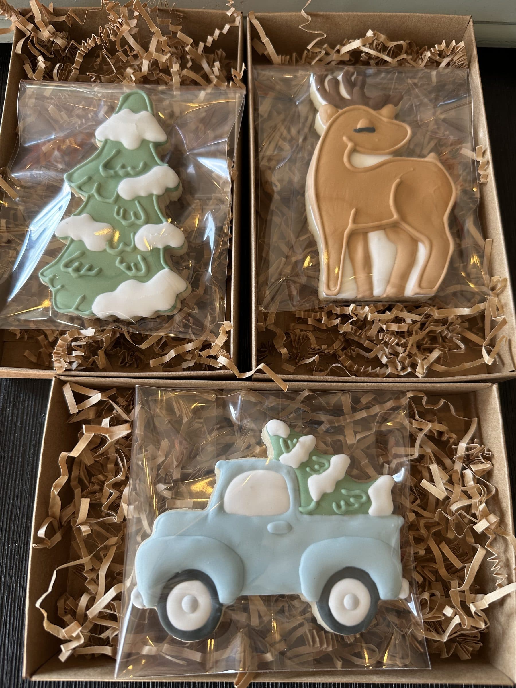 Christmas tree, reindeer, and vintage truck cookies in gift boxes