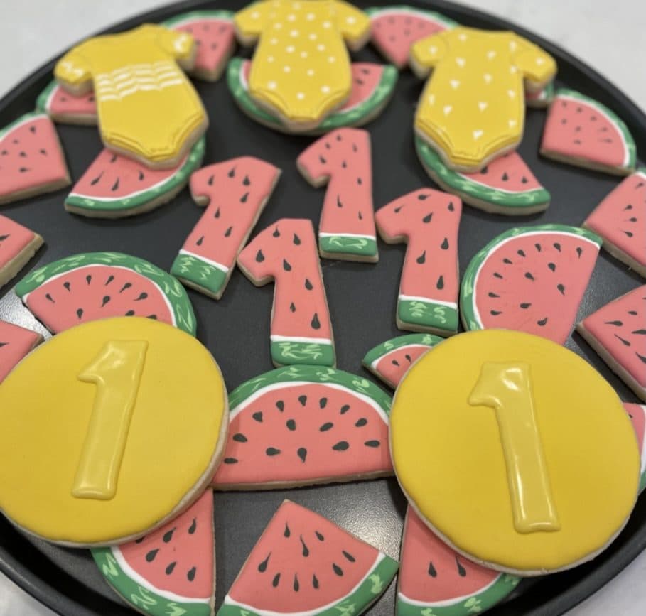 Watermelon, onesie, and number one cookies for a first birthday